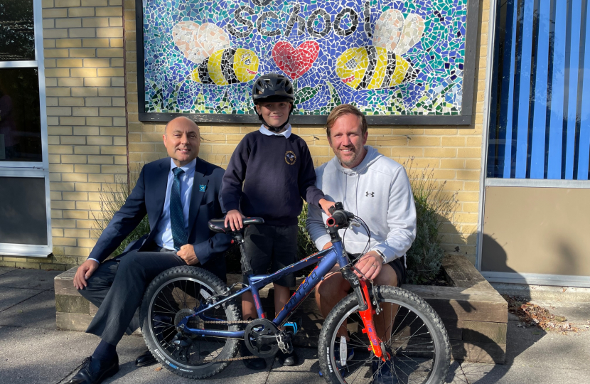 Andrew with young cyclist Rowan and teacher Mr Trent at Aldingbourne Primary School