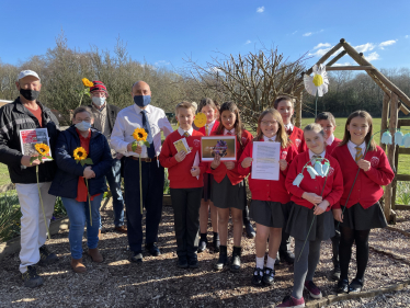 Andrew pictured with pupils of Arundel CofE Primary School before scattering their wildflower seeds.